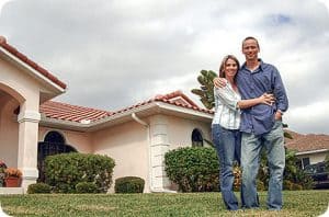 Couple in front of new house