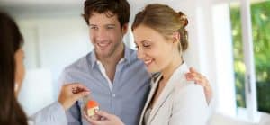 Couple being handed keys to a house
