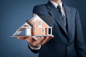 Man holding out a model home