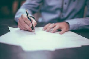 Man signing a form