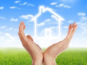 Hands holding white outline of a house - graphic