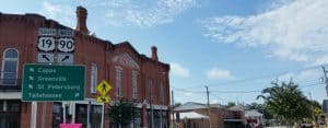 City street signs and large brick buildings