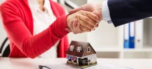 Shaking hands over mortgage documents