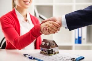 Shaking hands over mortgage documents