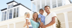 Young family in front of luxury home
