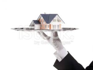 Butler holding a house on a platter