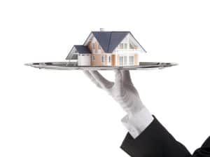 Butler holding a house on a platter