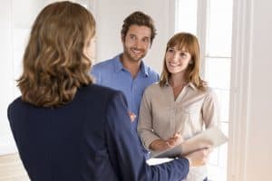 Young couple visiting apartment with real estate agent